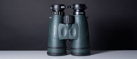A full view of the binoculars on a white table and black backdrop