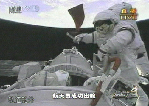 A Chinese taikonaut bears the flag of the People&#039;s Republic of China during the Shenzhou 7 mission&#039;s spacewalk on September 27, 2008.