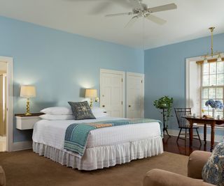 Blue bedroom at Bed and Breakfast with ceiling fan above bed, en suite bath and breakfast tray, Brampton Inn, Chestertown, Maryland, USA