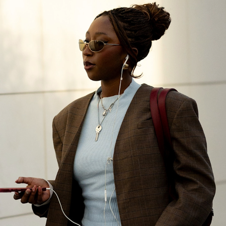 woman wearing a blue t-shirt and a brown blazer