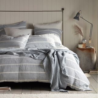 coastal style bedroom with grey striped bedlinen