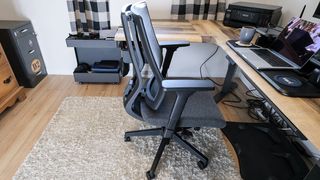 A side view of the Vari Task Chair at a desk