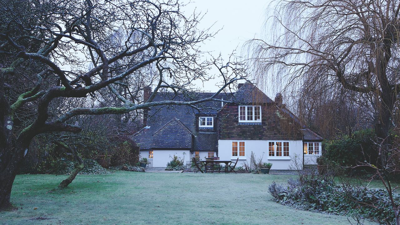 A house with a garden in the winter with a frosty grass