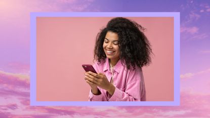 woman laughing on phone on a pink and purple sky background