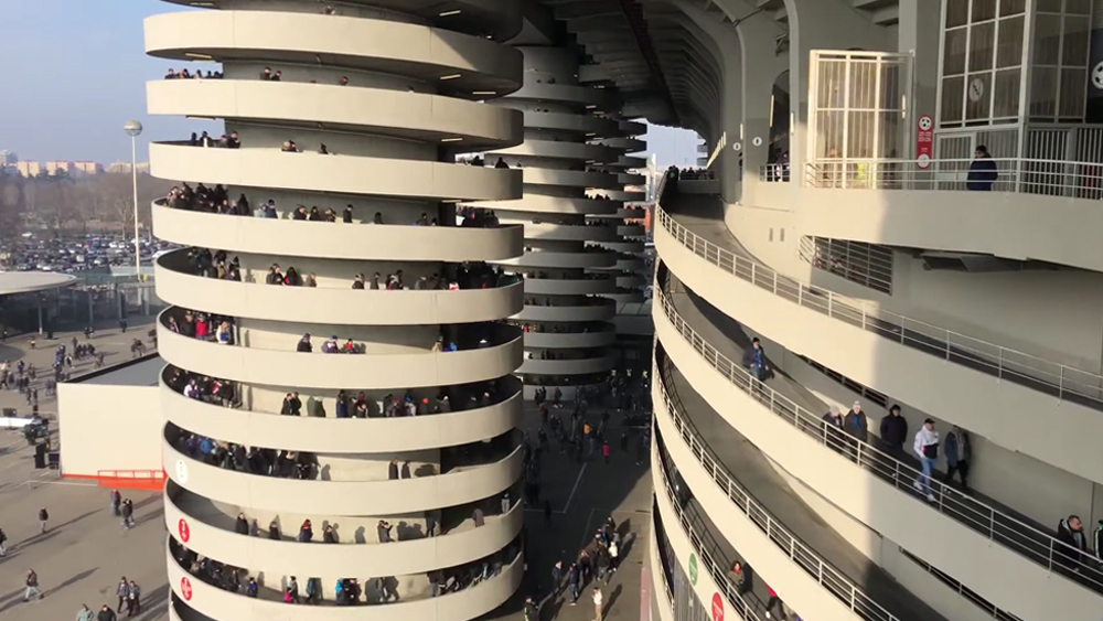 An image of San Siro Stadium in Milan showing an optical illusion that makes it look like spiral walkways are spinning when people walk on them