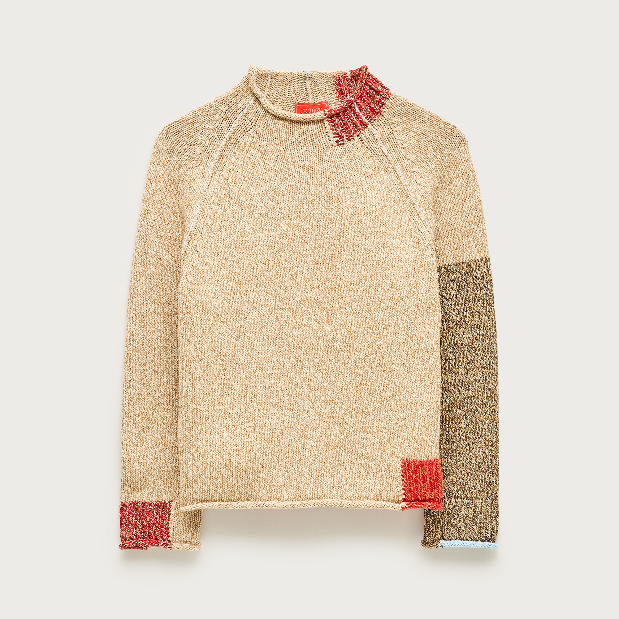 the J.Crew x Eckhaus Latta Rollneck sweater in front of a plain backdrop
