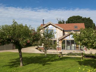 flat lawn with large apple trees outside self build