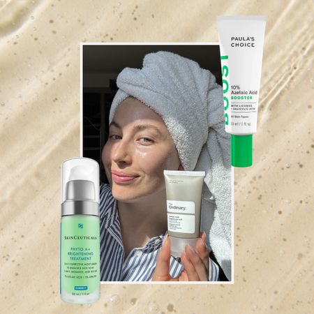 a woman in a white and blue striped shirt with a towel in her hair holding a gray and white bottle of skincare, next to a tan background with two green bottles of skincare