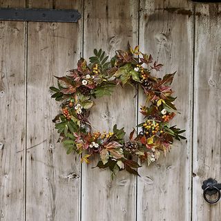 wooden door with autumn wreath