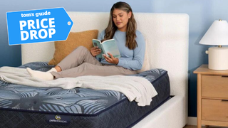 Woman sitting and reading on Serta mattress