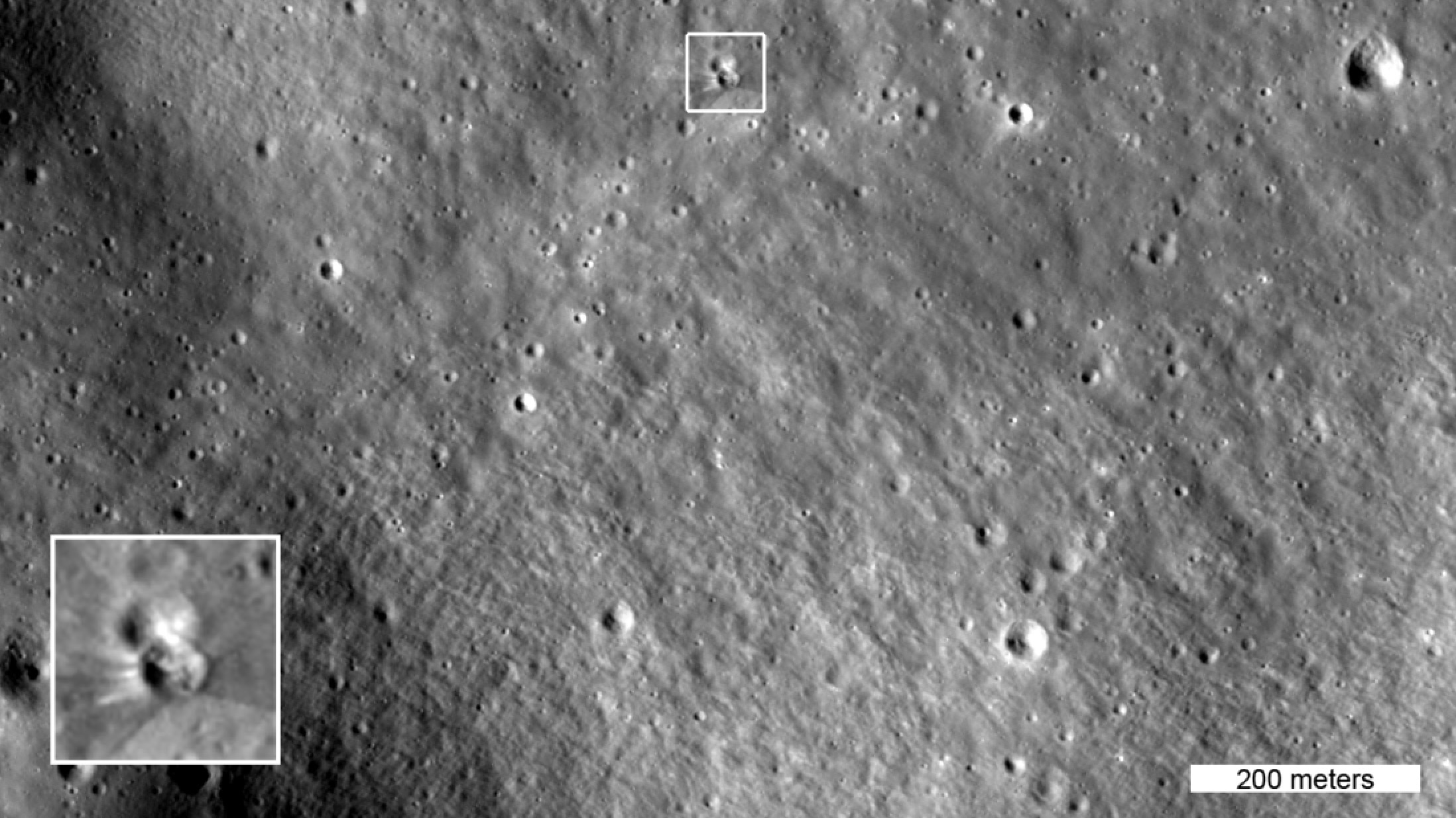 The box in this image highlights two small craters. The lower crater formed on Aug. 5, 2026 when a SpaceX Falcon 9 upper stage impacted the moon. The inset shows details of the new crater, enlarged three times. This image was captured by NASA&rsquo;s Lunar Reconnaissance Orbiter on Aug. 11, 2026 as it passed over the site at an altitude of 56 miles (90 kilometers).