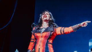 Cristina Scabbia smiling and pointing on stage