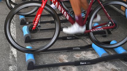A rider warming up on bike rollers.