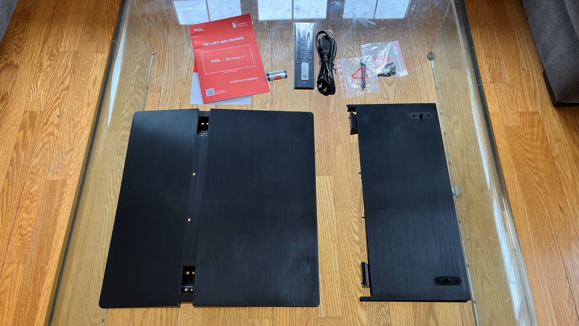 TCL QM7K on floor showing accessories