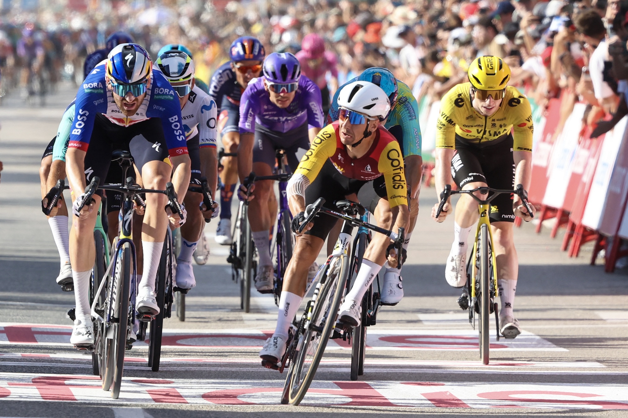 Team Cofidis' French rider Bryan Coquard (C) crosses the finish line to win the eighth stage of the Vuelta a Espana 2026, a 171 km race between Pucol and Xeraco on August 29, 2026. (Photo by Josep LAGO / AFP)