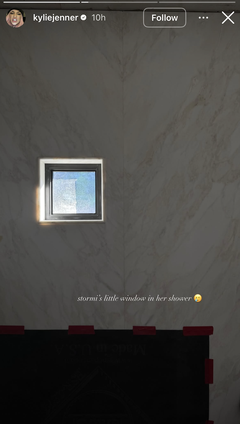 screenshot of kylie jenner's instagram story picture of small picture window built into white marble shower wall