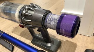 The filter being removed from the Dyson V11 cordless vacuum cleaner
