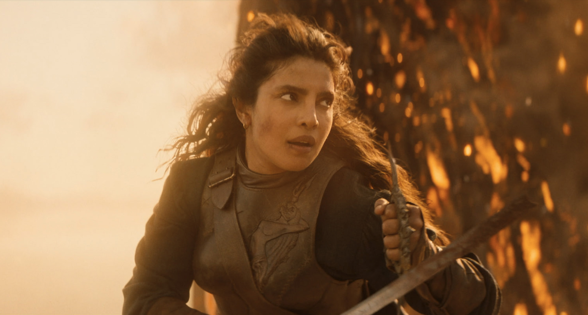 priyanka copra as a pirate in armor fighting on a ship engulfed in flames in a still from the 2026 action movie the bluff