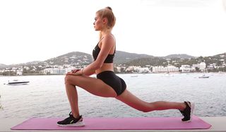 Pamela Reif doing a hip flexor stretch