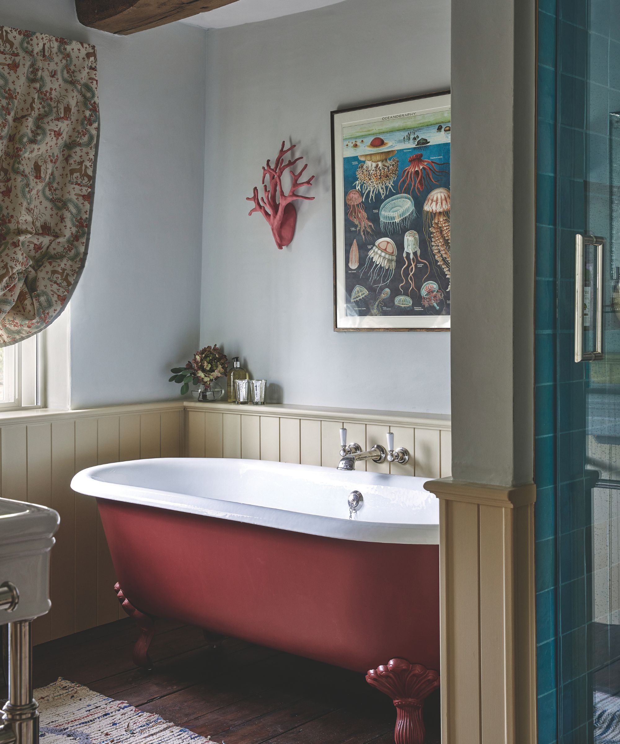 Pale blue bathroom with half wall paneling painted dark red
