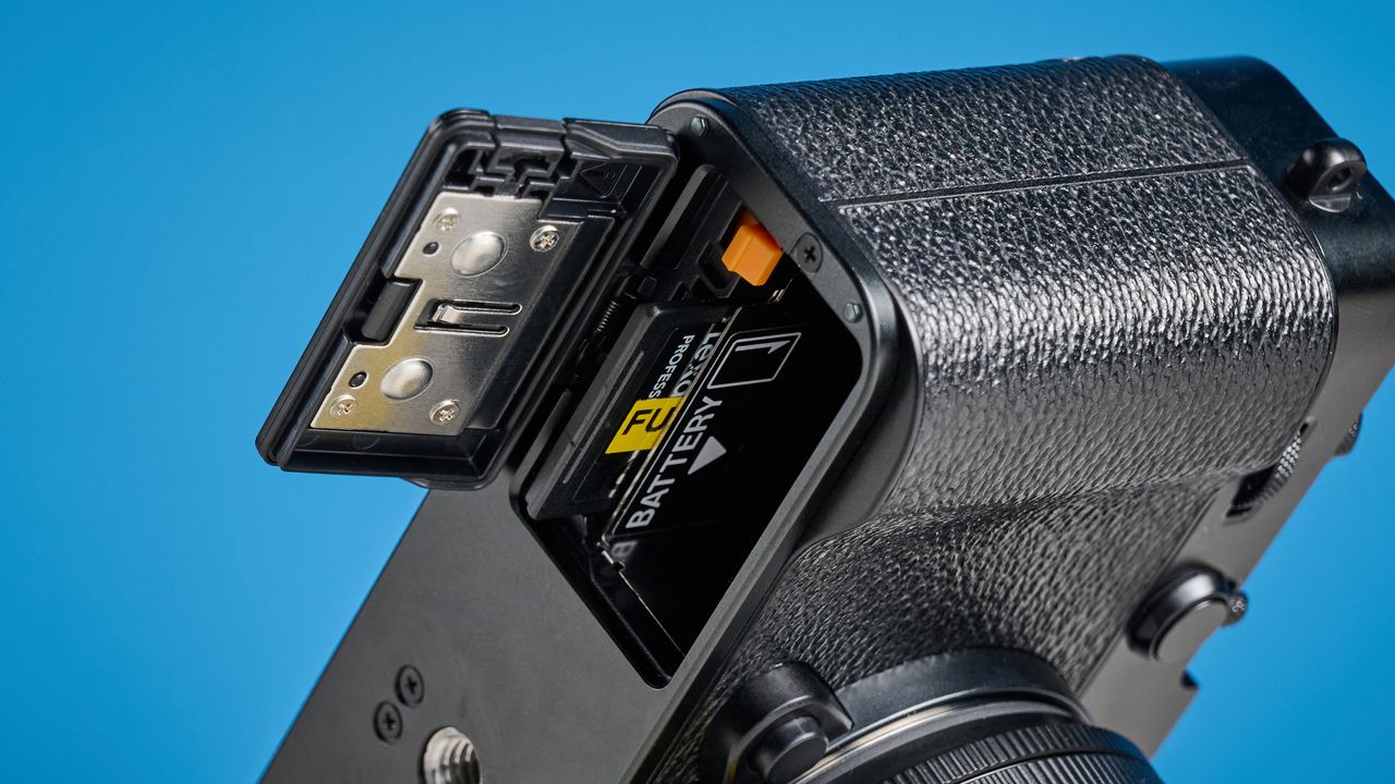 Fujifilm X-E5 card slot against a blue background