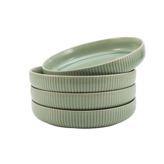 A stack of four sage green plate bowls