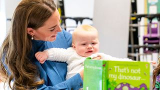 Britain's Catherine, Duchess of Cambridge holds 10-month-old son Saul Molloy during a Roots of Empathy session on her visit to St. John's Primary School in Glasgow on May 11, 2022.