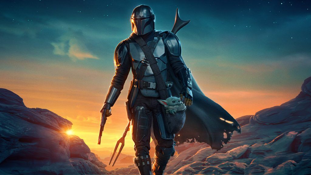 The Mandalorian walking in a desert scene.