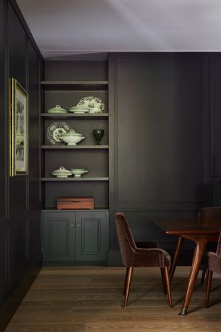Black dining room with alcove shelving by Cave interiors
