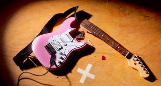 Smashed pink s-style electric guitar