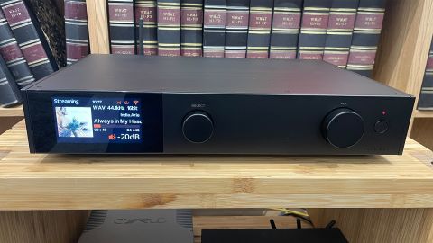 Audiolab 9000N music streamer on wooden hi-fi rack photographed from front showing colour display
