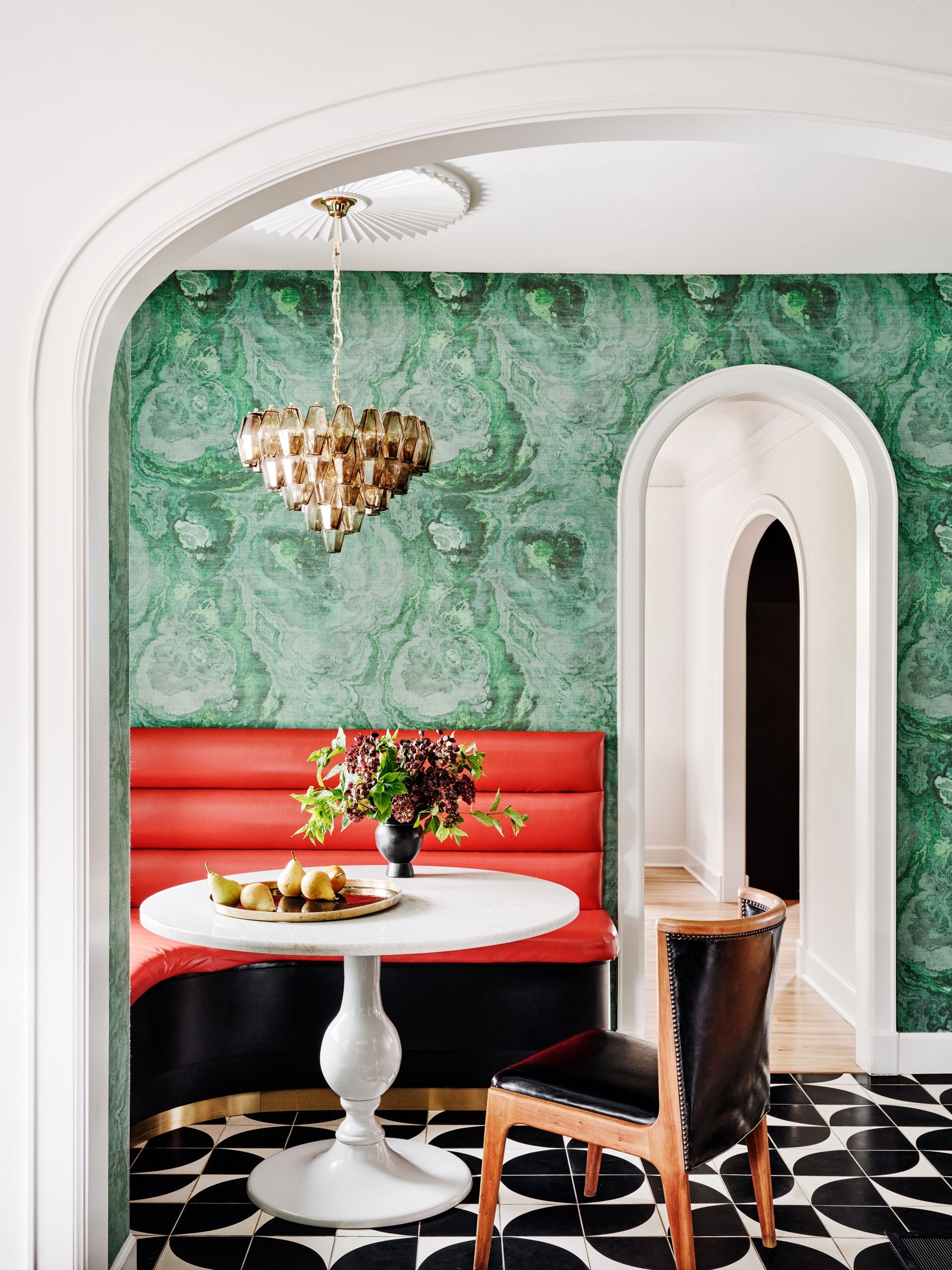 red bench seat with bright green wallpaper by Maestri Studio