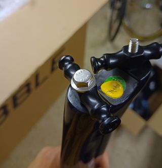 A seatpost with a large bolt in it