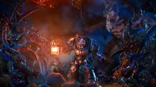 A lone Warhammer space marine holds a bright orange light and is surrounded by aliens which have a much cooler blue appearance around the edges of the frame