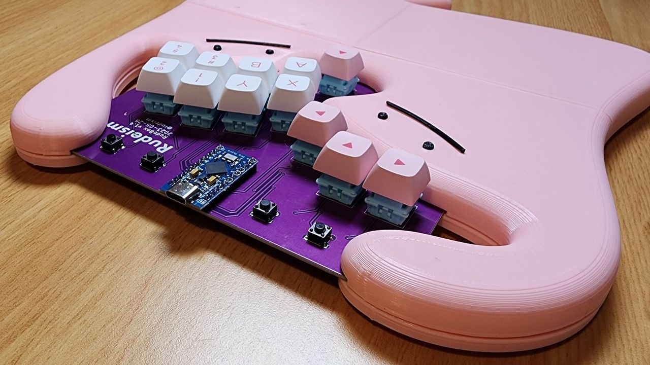 Rudeism's Rudebox custom fighting pad on a desk with wrist rest depicting two dittos