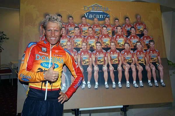 J&ouml;rg Ludewig in front of the team billboard