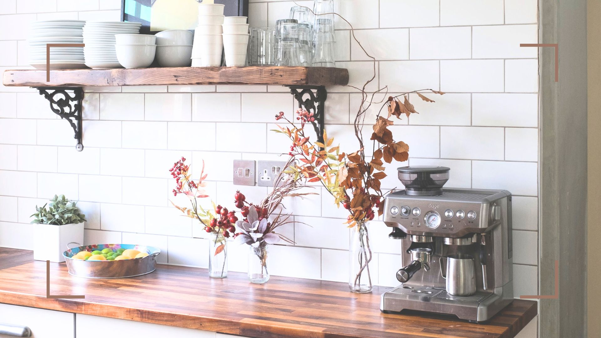 white kitchen with metro tiles and wooden worktops with a coffee machine on the side