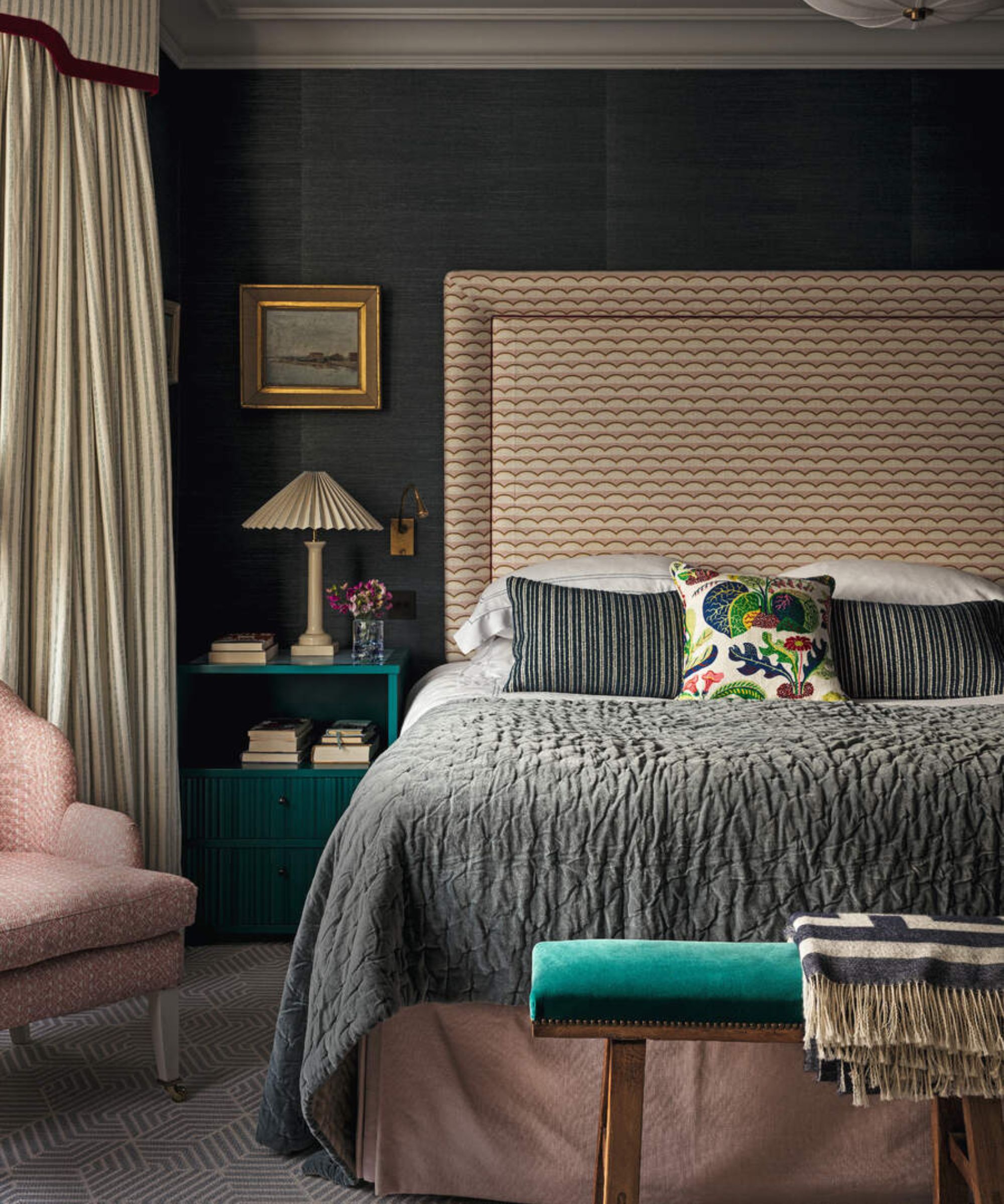 Green pillows on a beige bed frame against green walls.