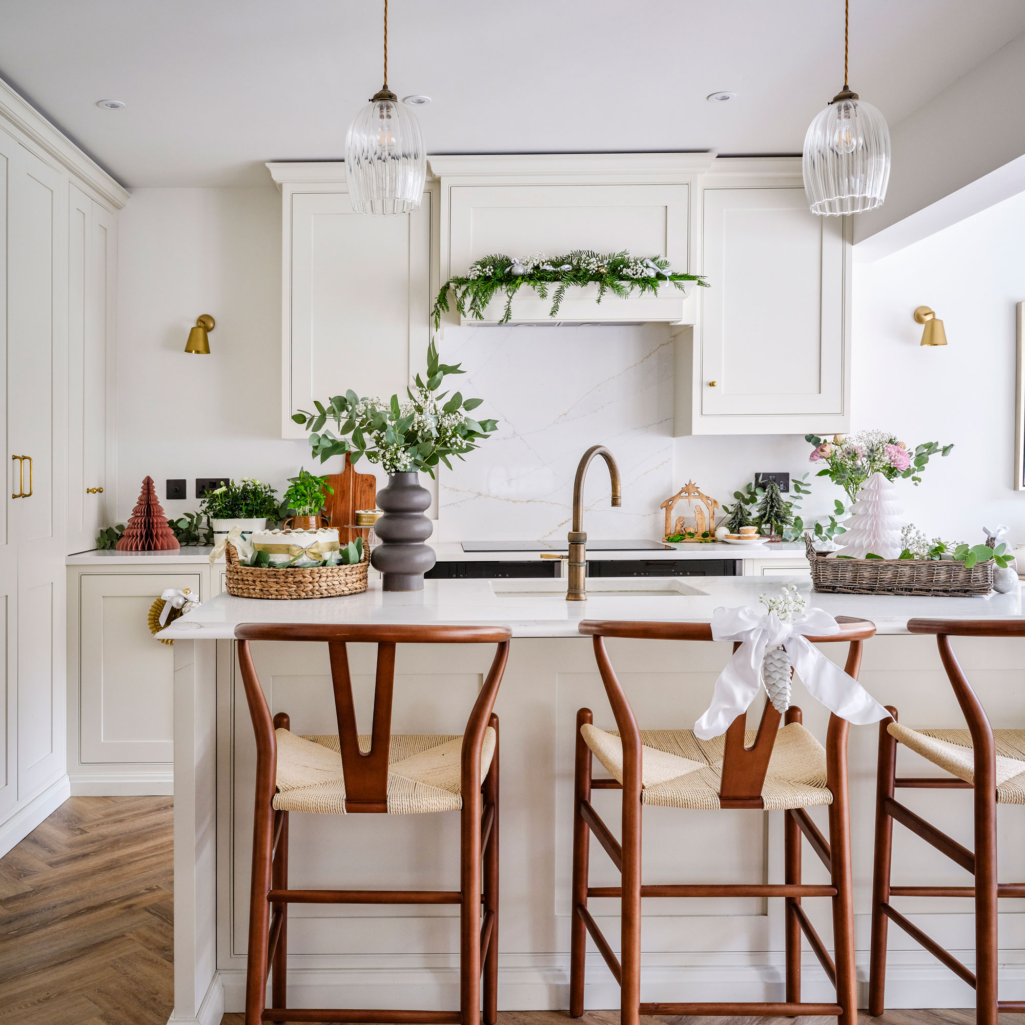 White kitchen with wishbone chair style stools