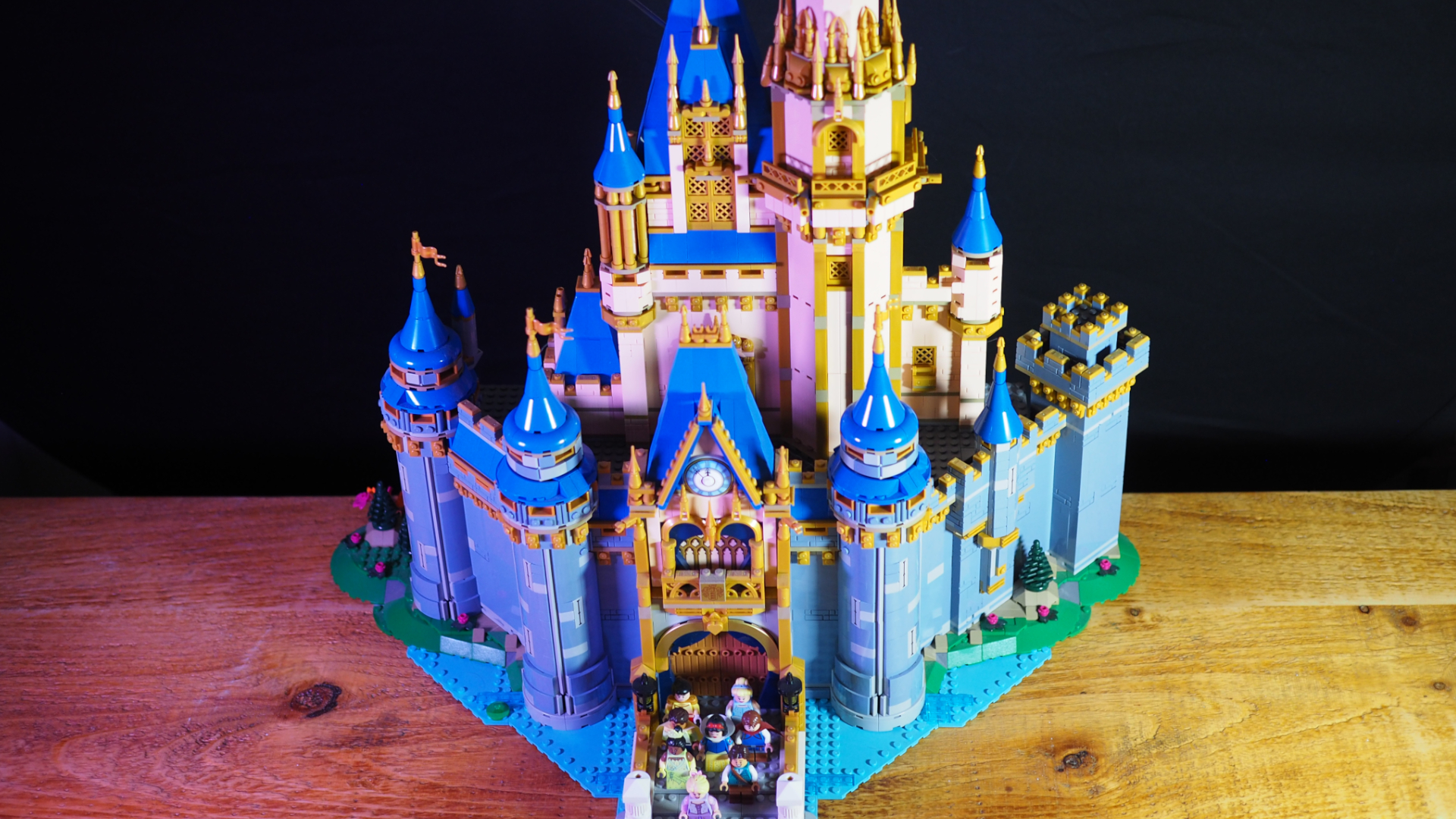 The Lego Disney Castle seen from above, sat on a wooden table against a dark background