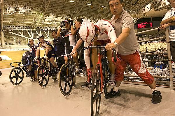 Strapping in for the ride of their life: Riders prepare for another mad dash in the mens' keirin.