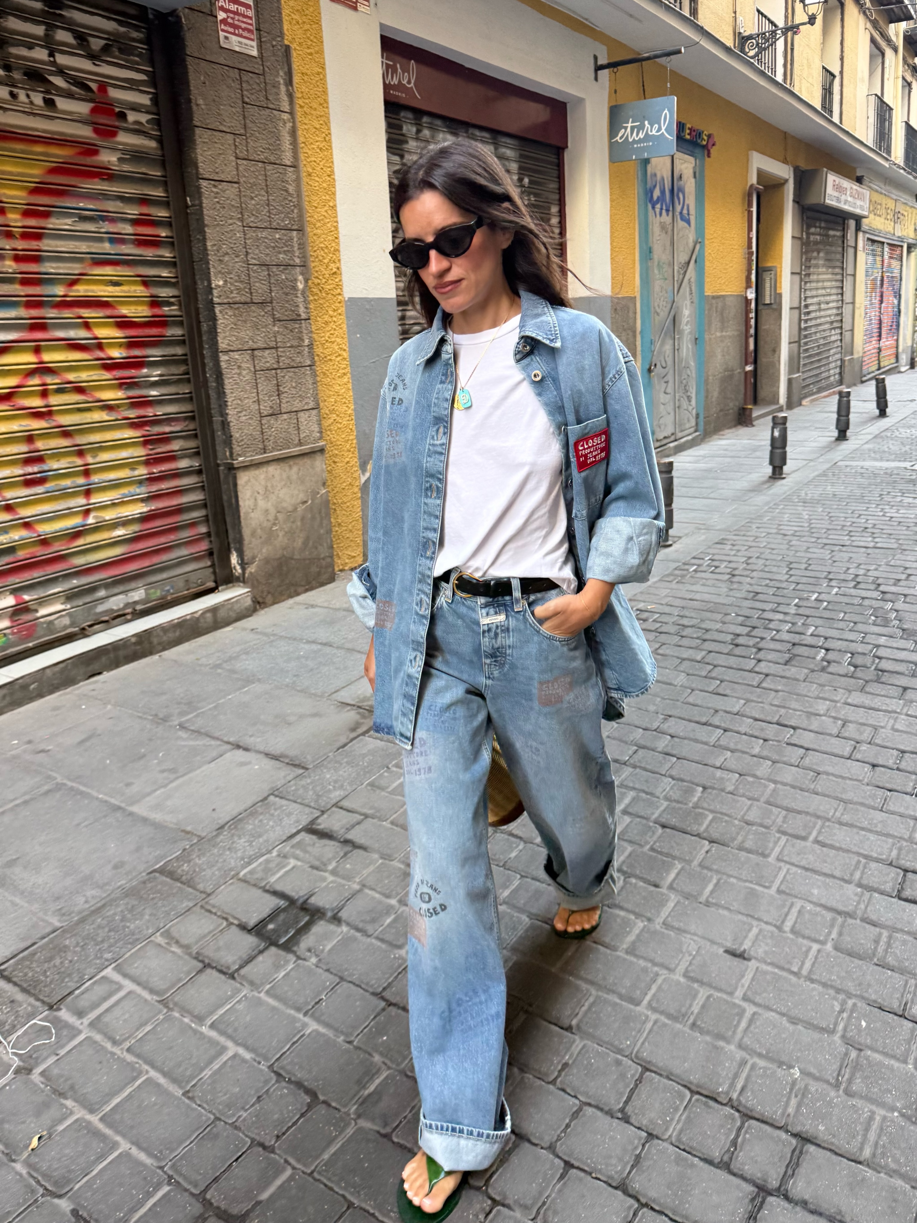 An image of a woman wearing summer to fall transitional denim outfit idea 2026