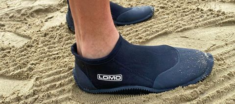 Man wearing Lomo 3mm Wetsuit Booties on sand