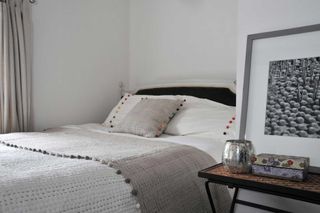 how to organize a small bedroom with a bed pushed into the corner