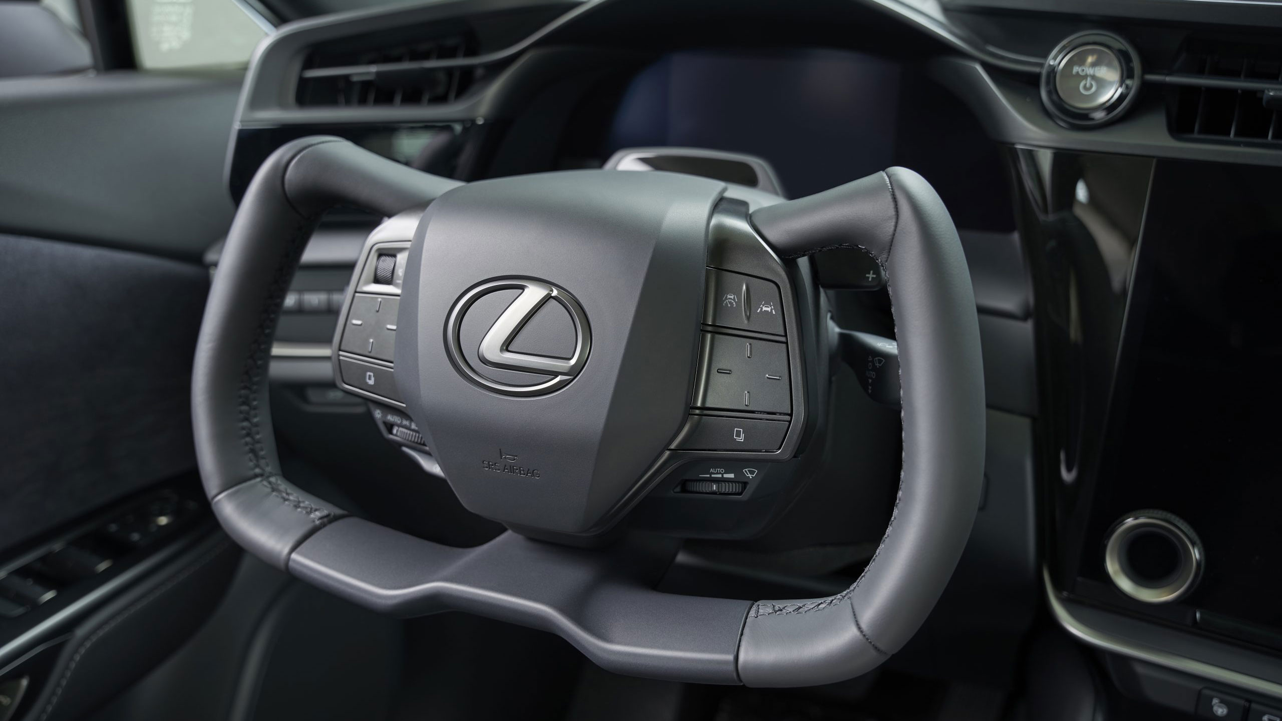 Angled, close-up of yoke steering wheel in the Lexus RZ 450e