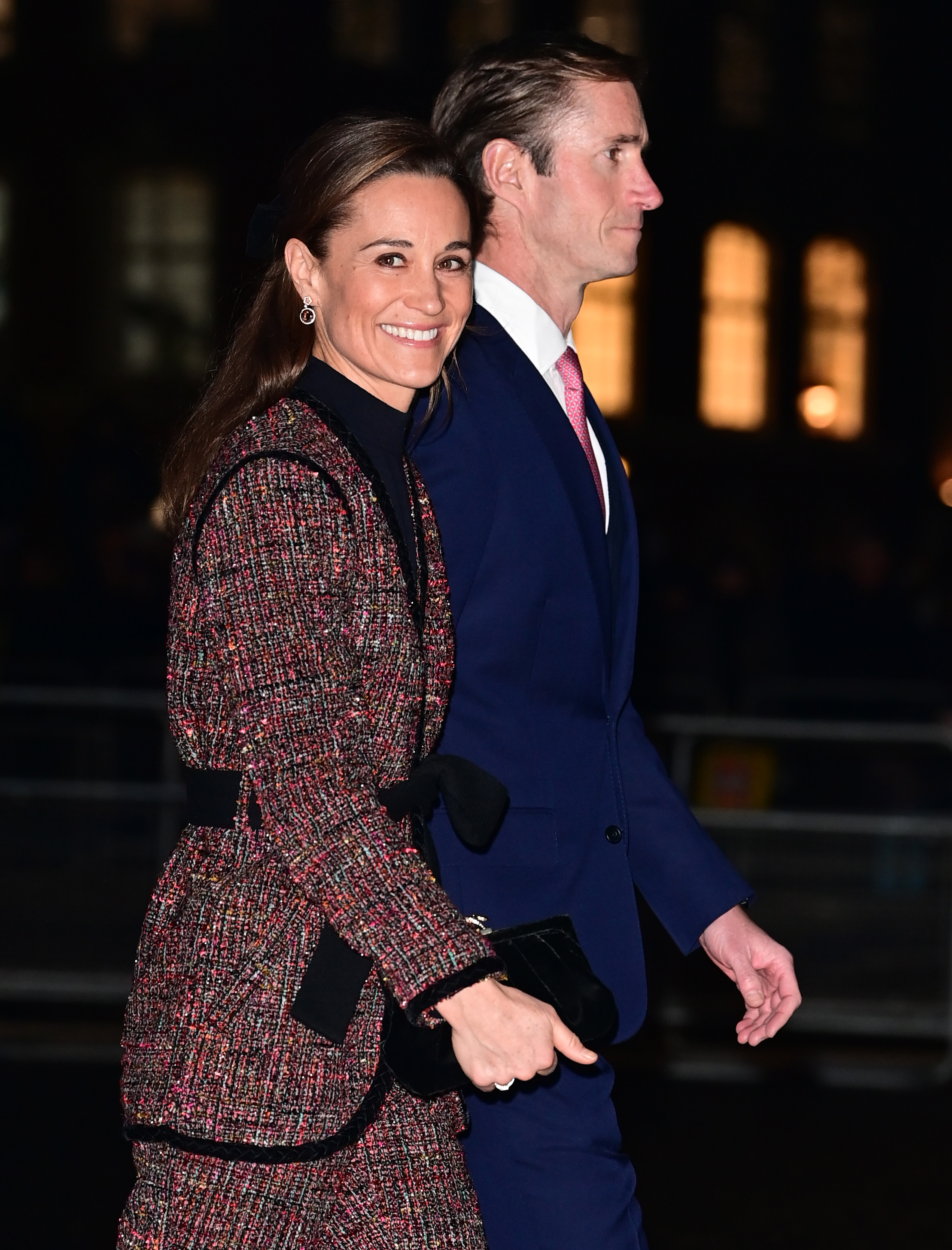 Pippa Middleton wearing a tweed suit walking next to husband James Matthews