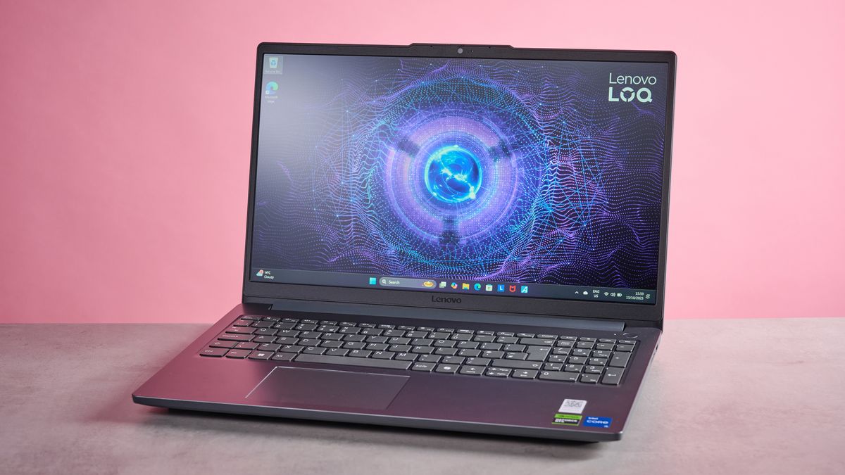 Three-quarter view of Lenovo LOQ Essential Gen 9 open on desk with pink wall in background