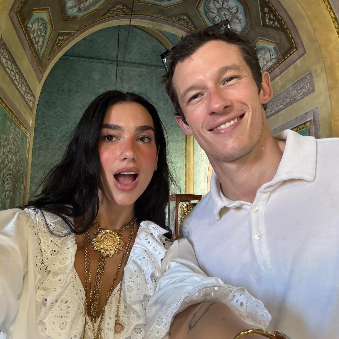 Dua Lipa wearing a pretty white shirt and denim shorts on vacation in Palermo, Italy