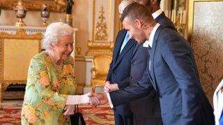 Queen Elizabeth greets David Beckham in Buckingham Palace