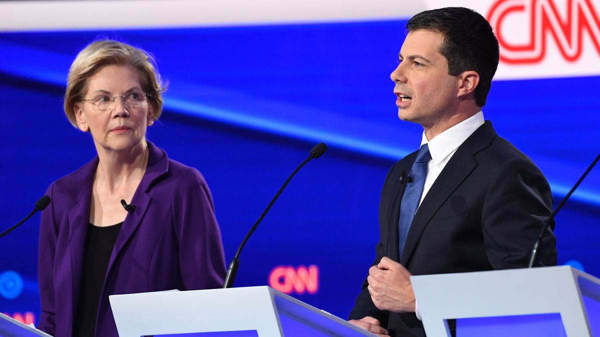 Democratic presidential hopeful Massachusetts Senator Elizabeth Warren (L) looks on as Mayor of South Bend, Indiana Pete Buttigieg speaks during the fourth Democratic primary debate of the 2020 presidential campaign season co-hosted by The New York Times and CNN at Otterbein University in Westerville, Ohio on October 15, 2019.